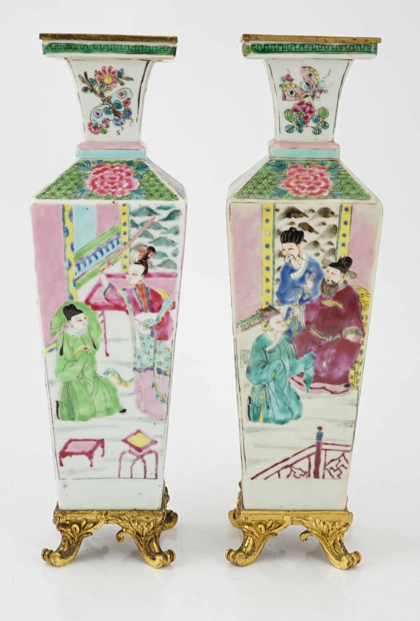 A pair of Chinese famille rose square baluster vases, late 19th/early 20th century, with European gilt metal mounts, each painted with figure scenes, total height 32cm
